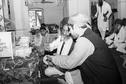 Farhan Wilayat taking Prasad at Gurdwara Dera Sahab, Lahore.jpg