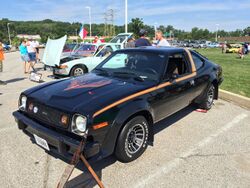 1978 AMC AMX at AMO 2015 meet in black with gold stripe 1of3.jpg