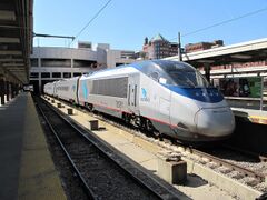 Stainless steel passenger trainset with a blue roof and a thin red sill stripe
