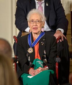 Johnson seated wearing her Presidential Medal of Freedom