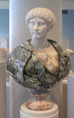 Museum bust with green verd antique drapery and an ancient Roman white Parian marble head of Agrippina Minor