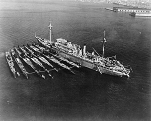 V-boats (left to right) Cachalot, Dolphin, Barracuda, Bass, Bonita, Nautilus, Narwhal, with submarine tender Holland