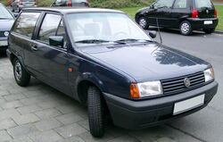 Front-three quarter view of a small three-door car with flush headlamps.