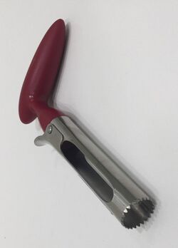 steel tube with one toothed end and an offset plastic handle on the other. Cutouts in the sides of the tube, and a lever just below the handle for pushing the core out of the tube.