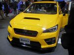Subaru WRX STI S207, a limited-production high-performance automobile. This is a front view of the car, showing its yellow color, hood scoop, and nameplate.