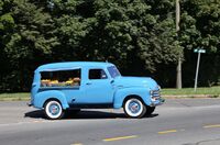 A blue 1953 Canopy Express from Chevrolet, loaded with fruits and vegetables