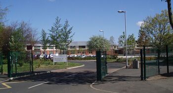 A modern two-storey school building at the end of a drive