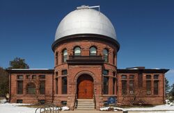 A brick building with silver domed roof.