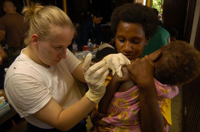 File:US Navy 050515-N-1485H-001 Hospitalman Mary Lewis, of Freemont, Mich., administers a tetanus shot to a child and her mother.jpg
