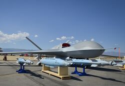 A Predator C Avenger unmanned aircraft system and inert ordnance sit on display on a tarmac at Palmdale, Calif., Aug. 8, 2012 120808-N-WL435-054.jpg