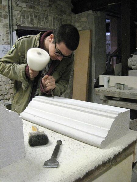 File:American College of the Building Arts junior carving a stone mantle.jpg