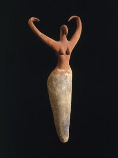 A crude statuette of a nude woman