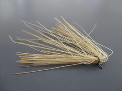 Tuft of stiff fibers removed from a brush