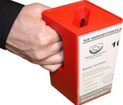 Hand holding a red fundraising box.jpg