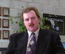 A photo of Ian Hetherington, founder of game developer Psygnosis, seated at a desk.
