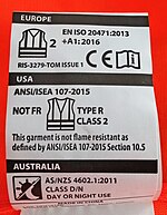 A tag on a high visibility vest, identifying it as complying with ISO 20471:2013