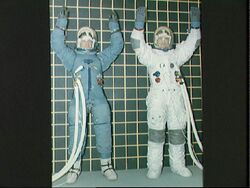 Two astronauts check mobility of different types of Apollo space suits (5134456205).jpg