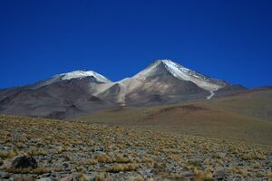 Uturuncu is a cone in a desolate landscape, with an adjacent smaller non-conical mountain.