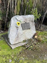 Memorial stone with flower and plaque