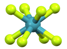 A greenish-blue central atom surrounded by and bonded to eight yellowish-green atoms arranged in a square antiprismatic fashion.