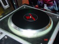 A turntable at the right side of the cabinet's "Player 2" controller.