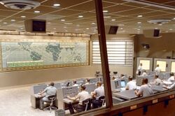 A look inside the Mercury Control Center, Cape Canaveral, Florida. Dominated by the control board showing the position of the spacecraft above ground