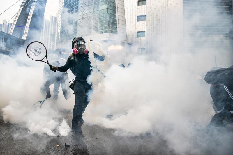 File:Protesters use tennis rackets to bat away tear gas. (50267655062).jpg