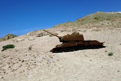 Russian/Soviet tank half-buried in sand on the beach on the island of Socotra in modern Republic of Yemen