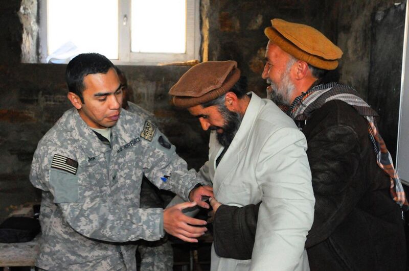 File:US medic teaches the Heimlich manuever to laughing Afghans.jpg
