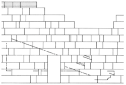 Architectural black on white sketch of a wall missing some stones, with a door at the center and carving marks on the wall surface.