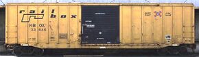 A yellow boxcar with a Railbox logo painted in black