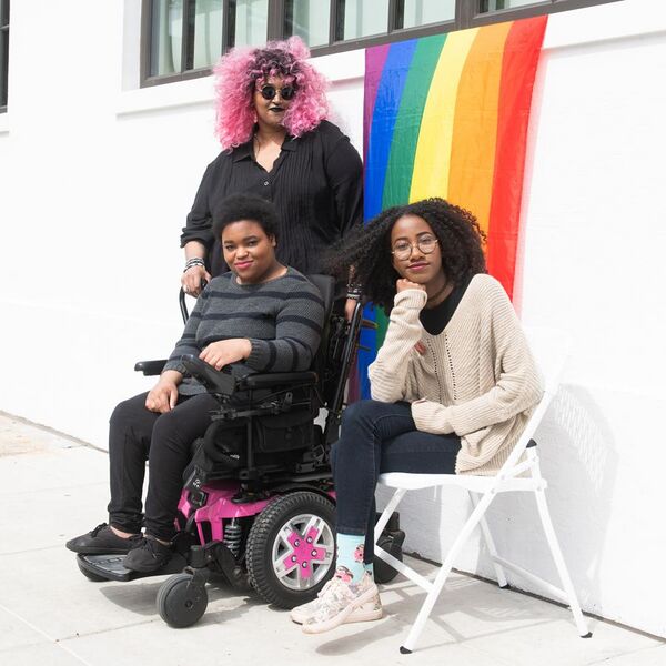 File:Disabled BIPOC in front of pride flag.jpg