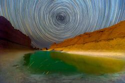 Star trail photography on salt lake in Lut desert in Iran