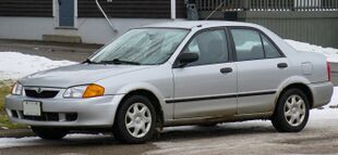 1999 Mazda Protegé LX in Highlight Silver Metallic, Front Left, 12-07-2022.jpg