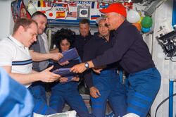 STS117 crew give packages.jpg