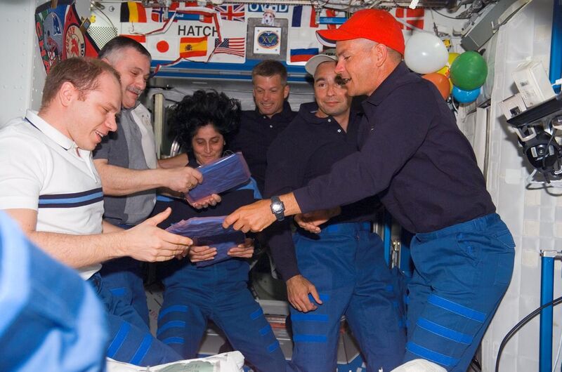 File:STS117 crew give packages.jpg