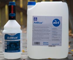 A small bottle and a large cannister, both labeled as "AdBlue"