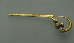 Photograph of a gold brooch