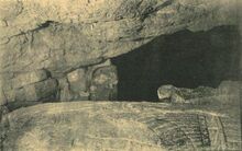 Monochromatic image of a portion of a stone sarcophagus (the sarcophagus of Ahiram) in a cave-like burial chamber
