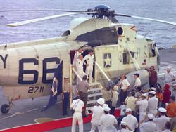 The Apollo 8 crew shown disembarking Helicopter 66 aboard USS Yorktown following their return to Earth