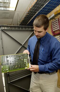 Technician checks circuit card.jpg
