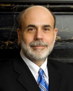 Bernanke smiling, wearing a suit