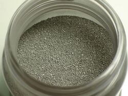 A small canister of metallic powder