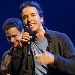 Craig Kielburger at We Day Waterloo 2011 with his brother, Marc Kielburger, in the background.jpg
