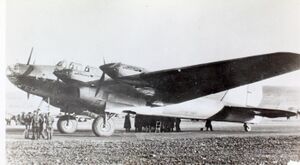 Three-quarters view of a large four-engined parked aircraft with a conventional undercarriage