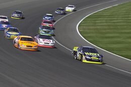 US Navy 040501-N-1336S-037 The U.S. Navy sponsored Chevy Monte Carlo NASCAR leads a pack into turn four at California Speedway.jpg