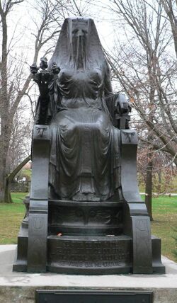 Statue of a woman on a throne covered by a veil