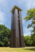 A brown, square bell tower in Berlin, Germany
