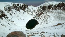 Aerial view of Licancabur Lake, surrounded by snow