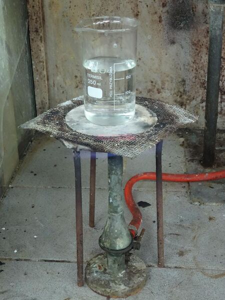 File:A laboratory heat spreader made of asbestos, over Teclu burner.jpg